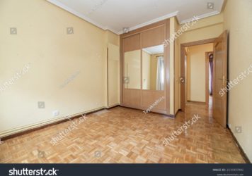 https://flooringjunction.com.au/wp-content/uploads/2022/10/stock-photo-empty-room-with-oak-parquet-yellow-painted-walls-and-fitted-wardrobe-with-sliding-mirror-doors-and-2135927241-356x250.jpg